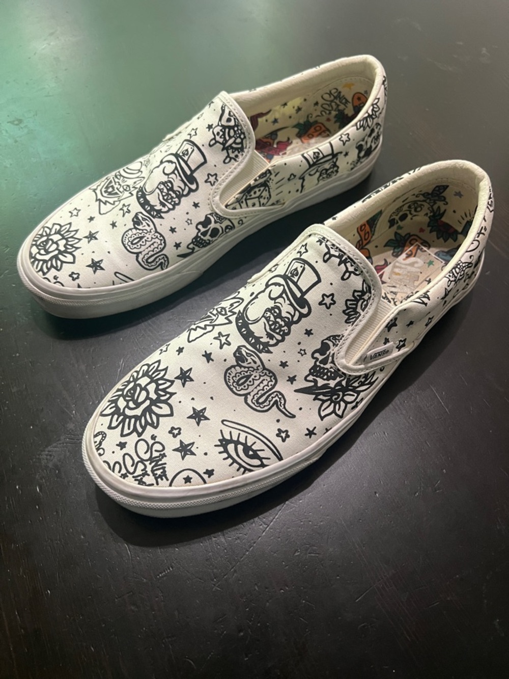 Vans White Canvas Slip-On Sneakers with Black Tattoo Graphics